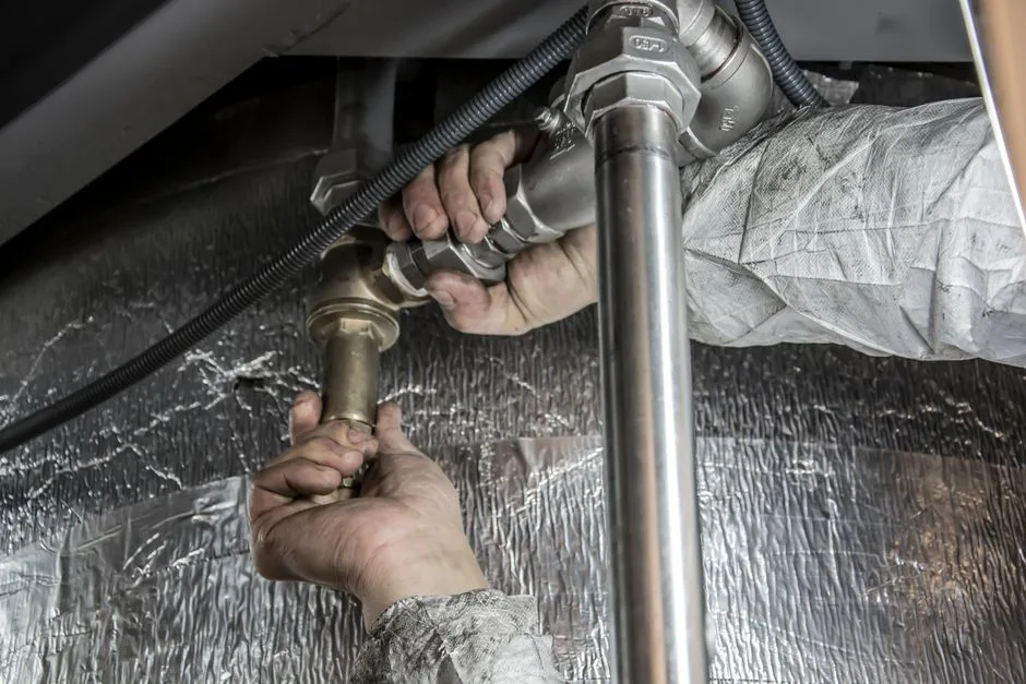Close-up of industrial pipe installation at a commercial construction site